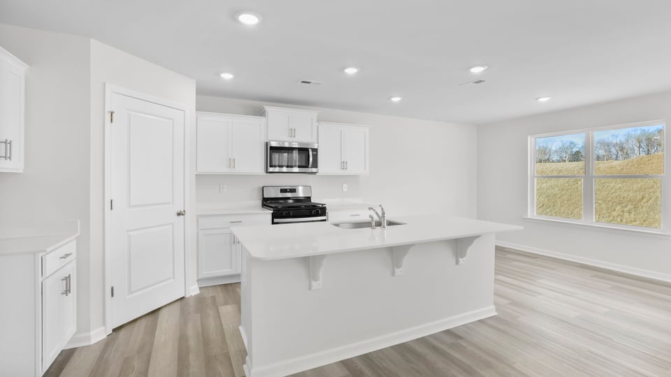 Kitchen with island and cabinets.