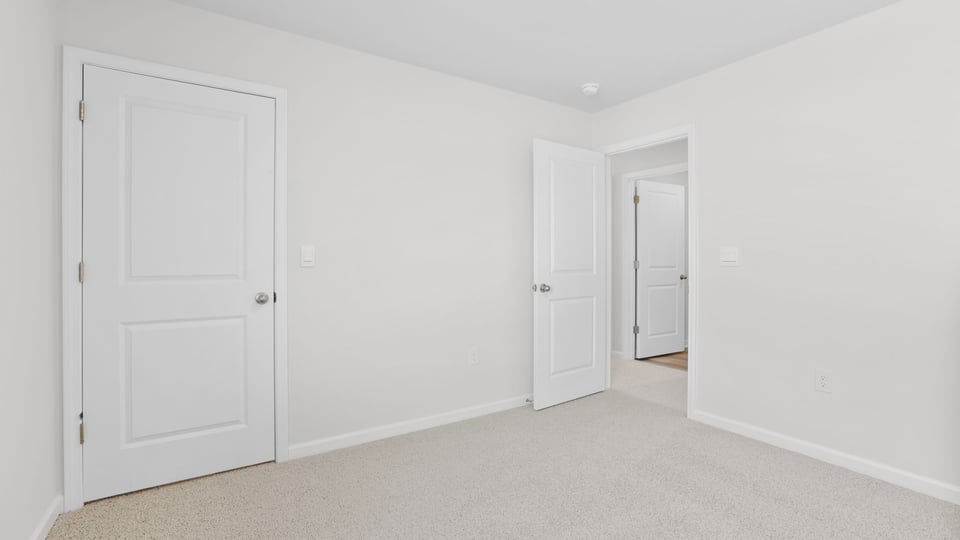 Bedroom with carpet and window.