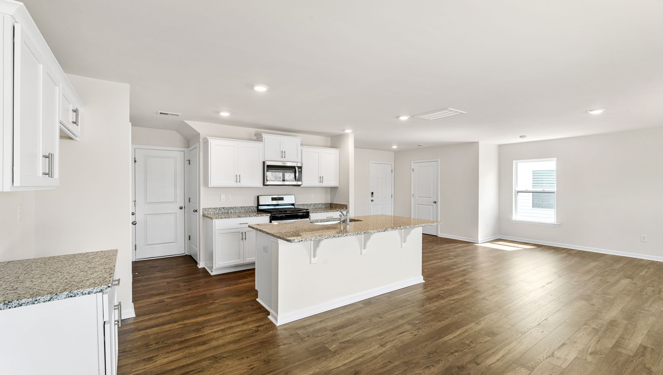 Kitchen with island and granite countertops.