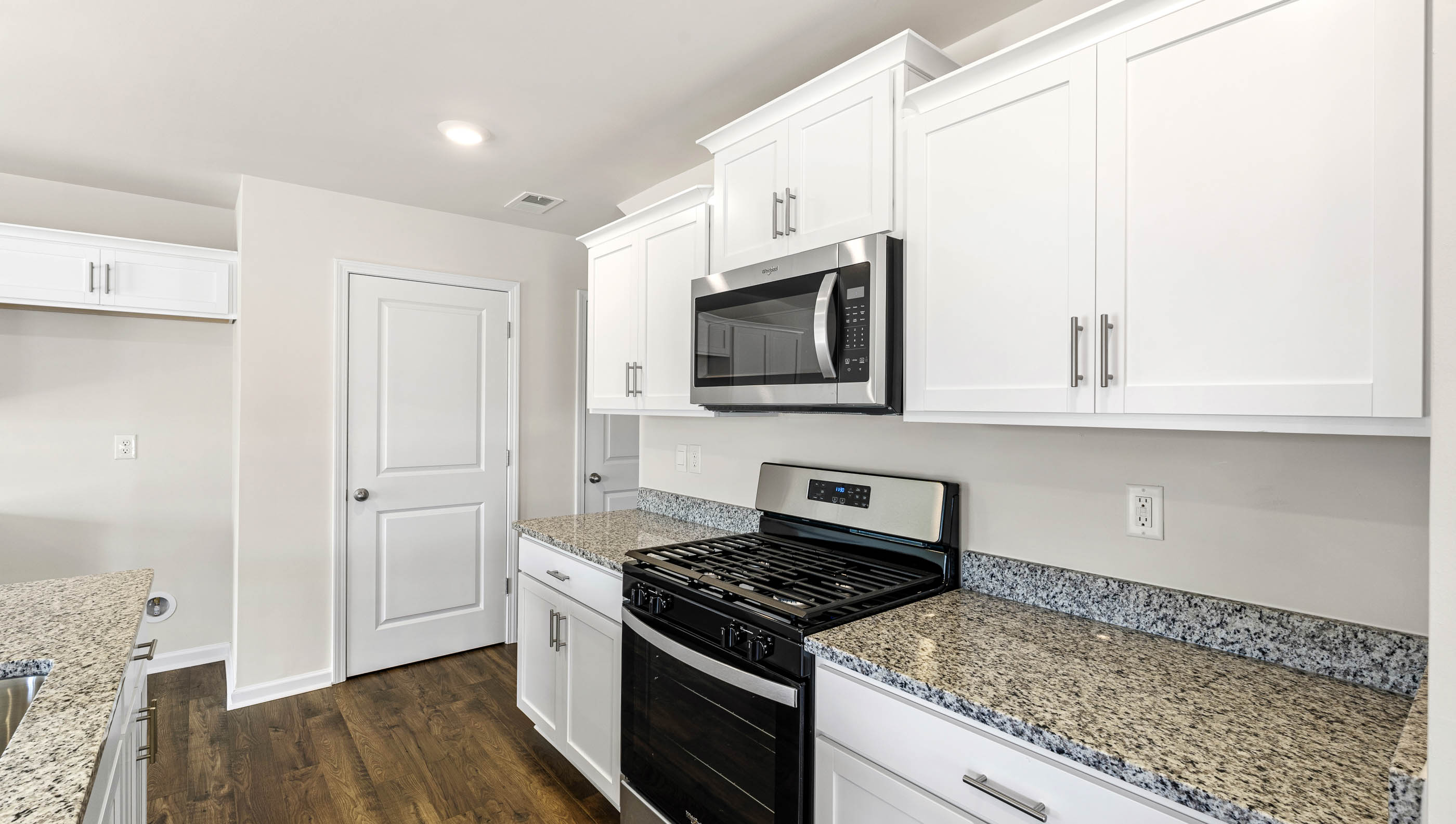 Kitchen with island and granite countertops.