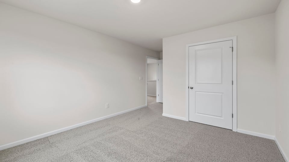 Bedroom with carpet and window.