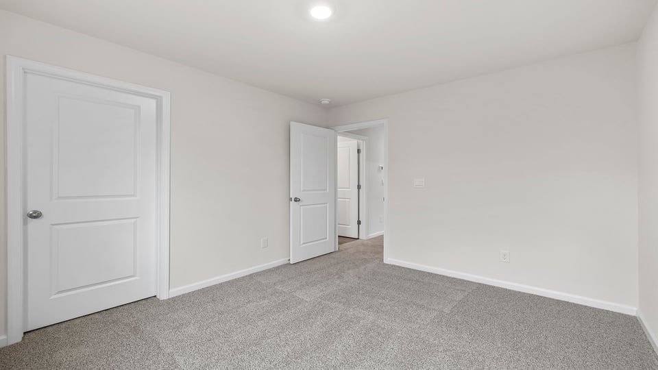 Bedroom with carpet and window.