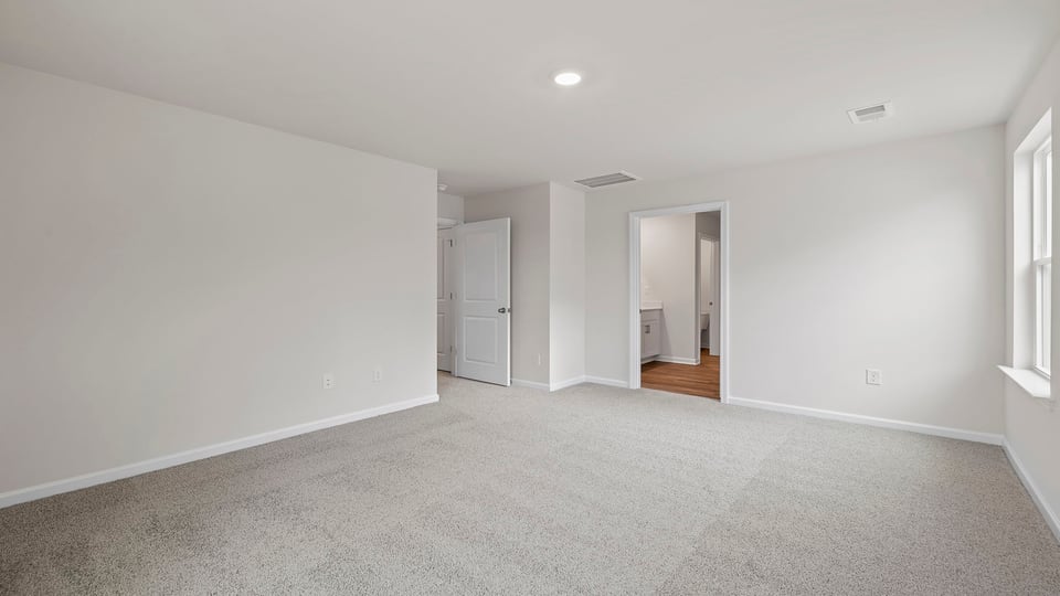 Bedroom with carpet and window.