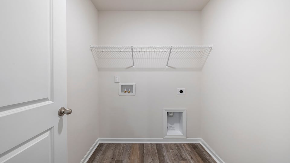 Laundry room with storage shelves.