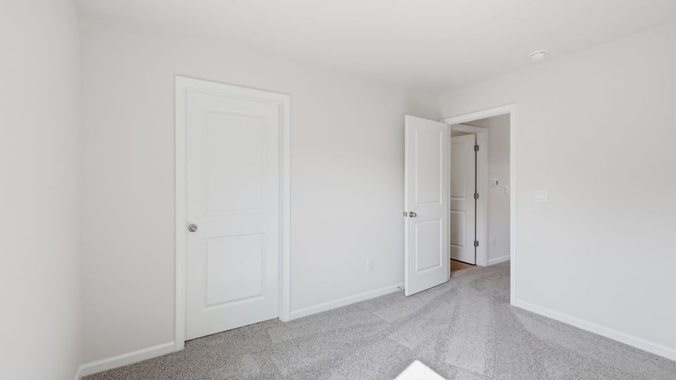 Bedroom with carpet and window.