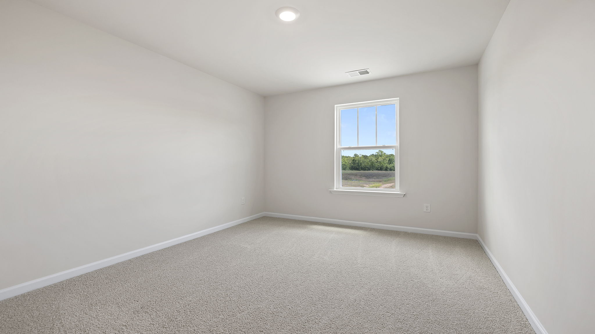 Loft area with carpet and window.