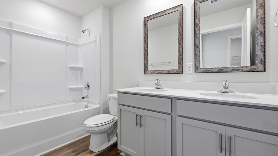Bathroom with double vanity sink and bathtub.