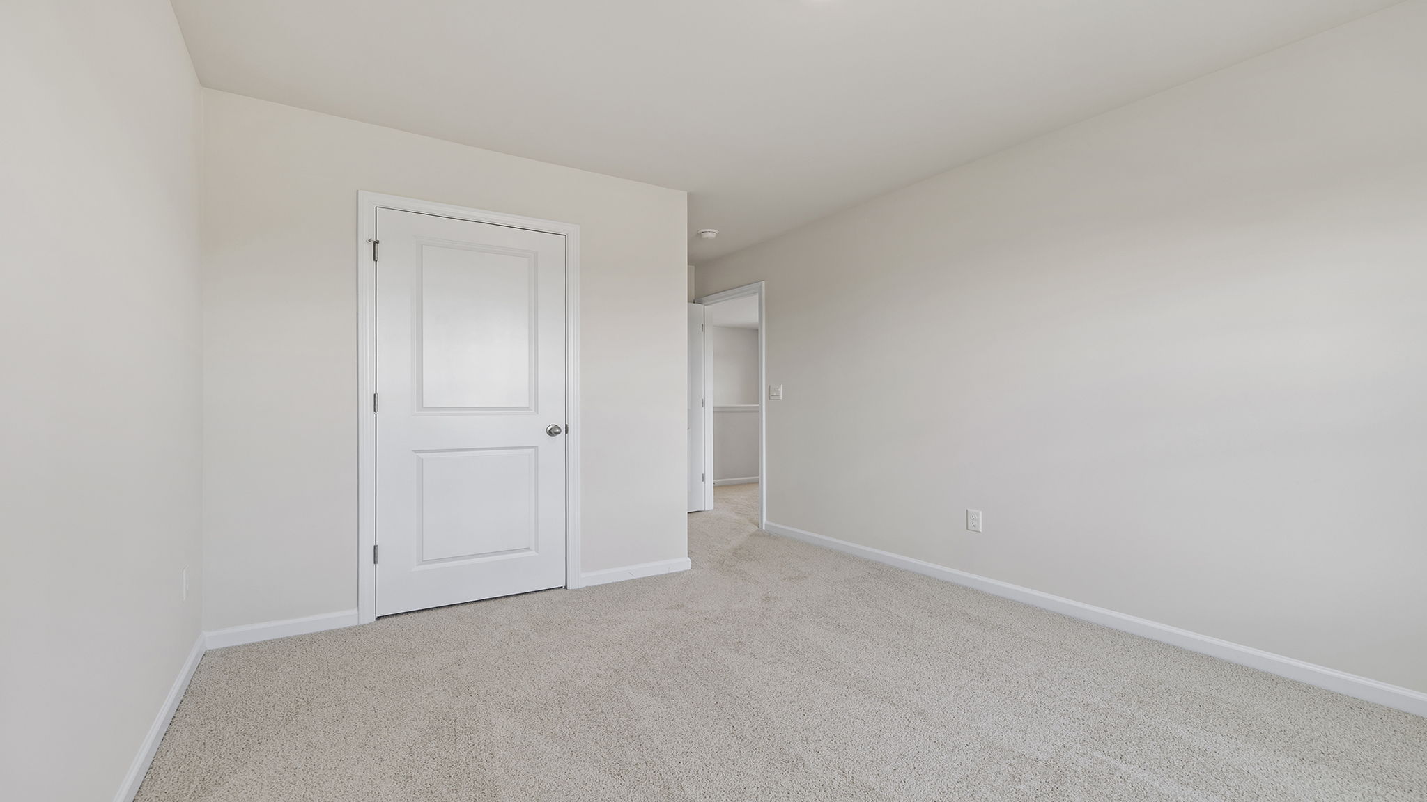 Bedroom with carpet and windows.