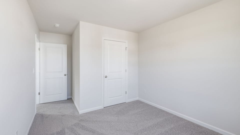 Bedroom with carpet and window.