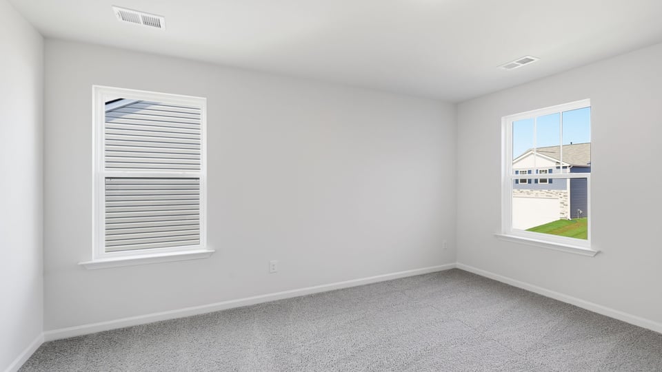 Bedroom with carpet and window.