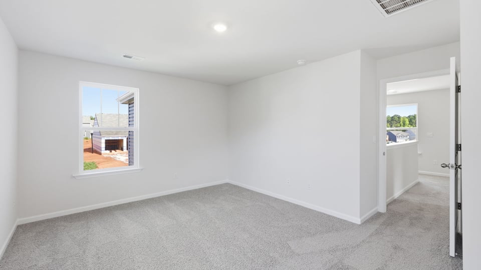 Bedroom with carpet and window.