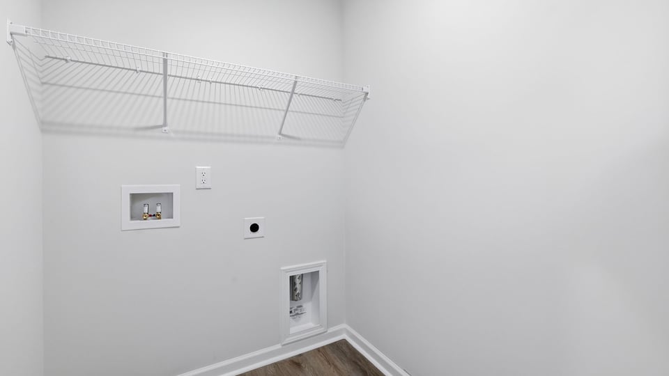 Laundry room with hanging storage racks.