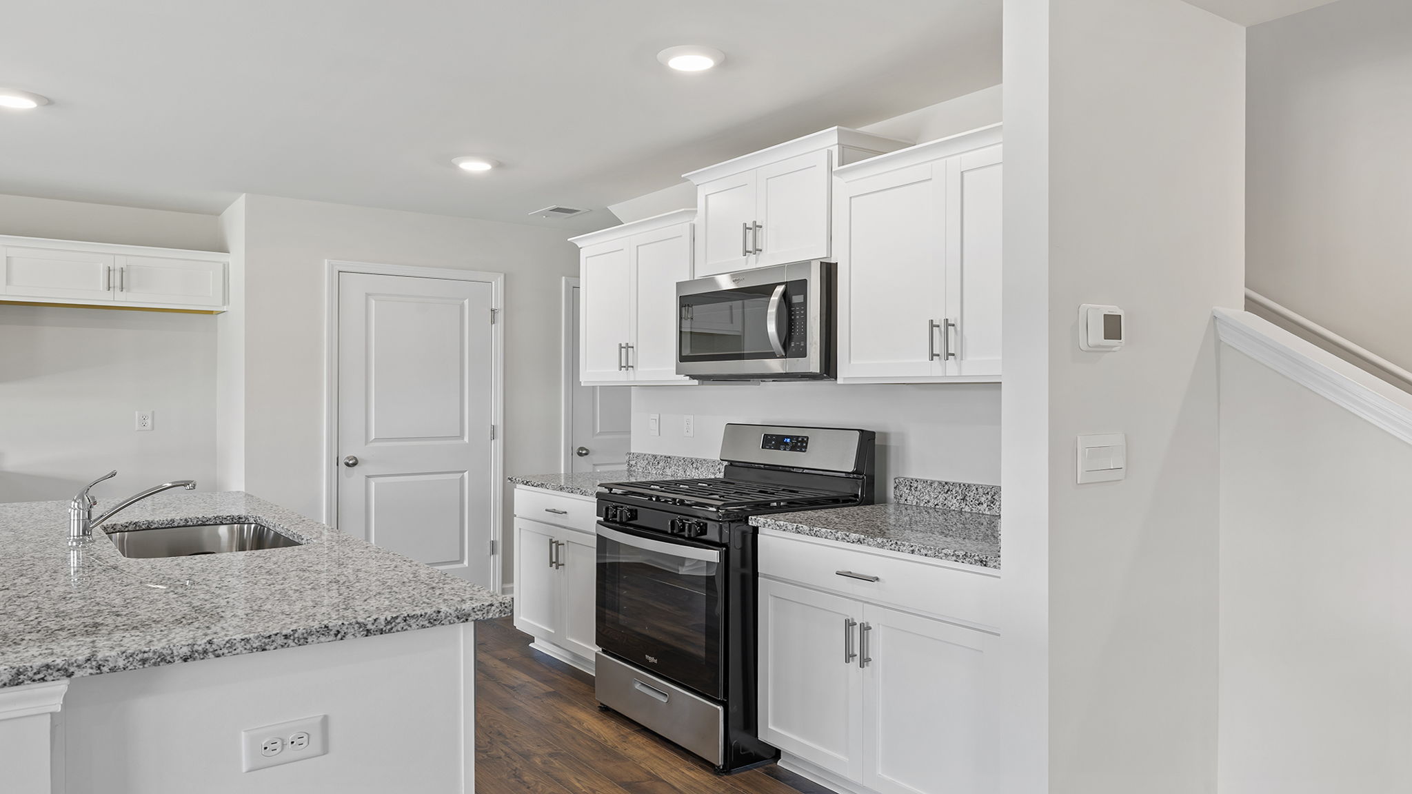 Kitchen with island and cabinets.