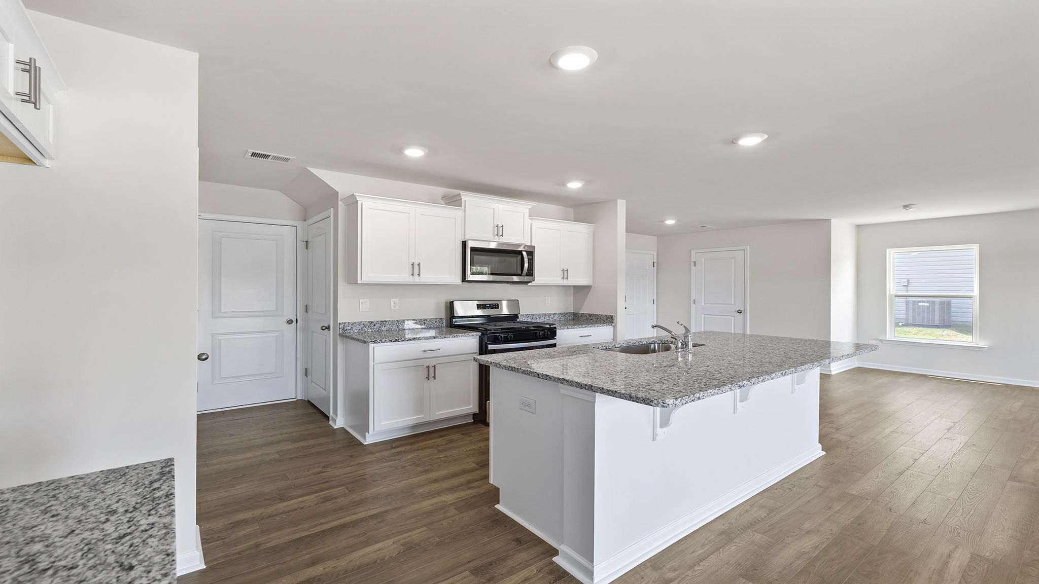 Kitchen with island and cabinets.