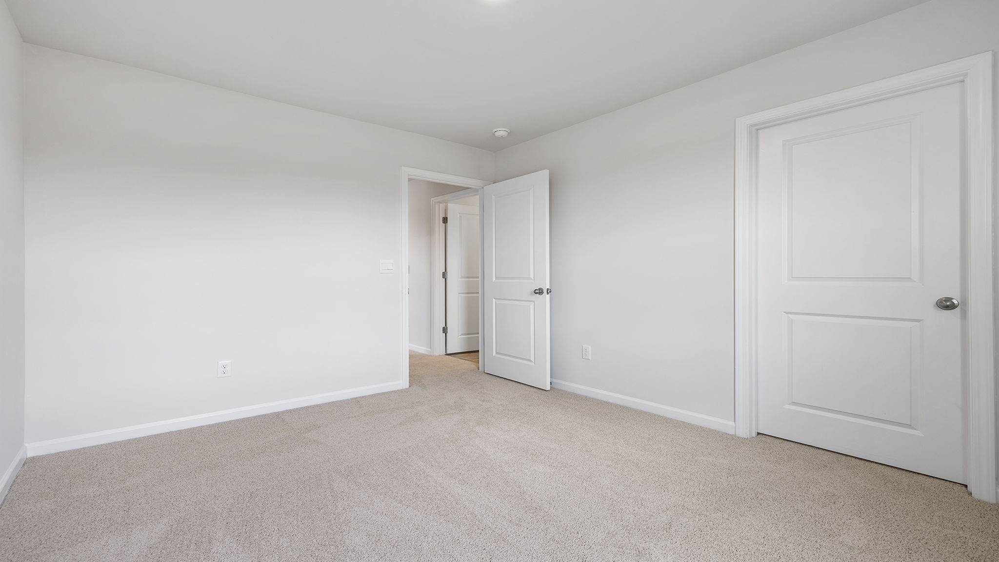 Bedroom with carpet and windows.