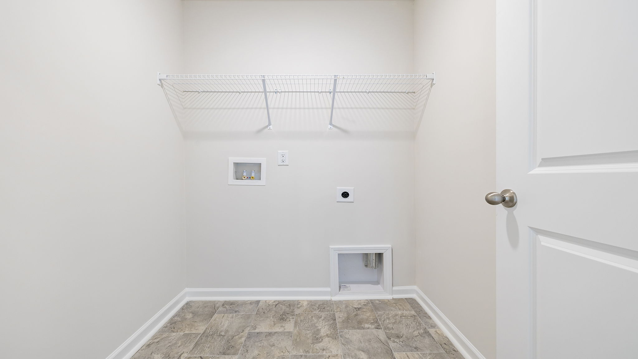 Laundry room with shelf.