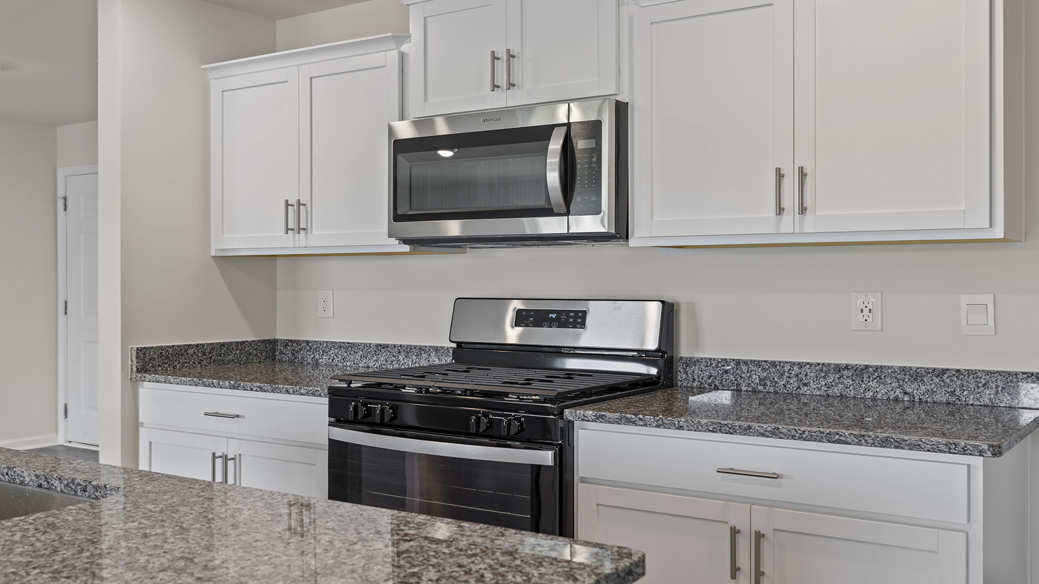 Kitchen with island and cabinets.