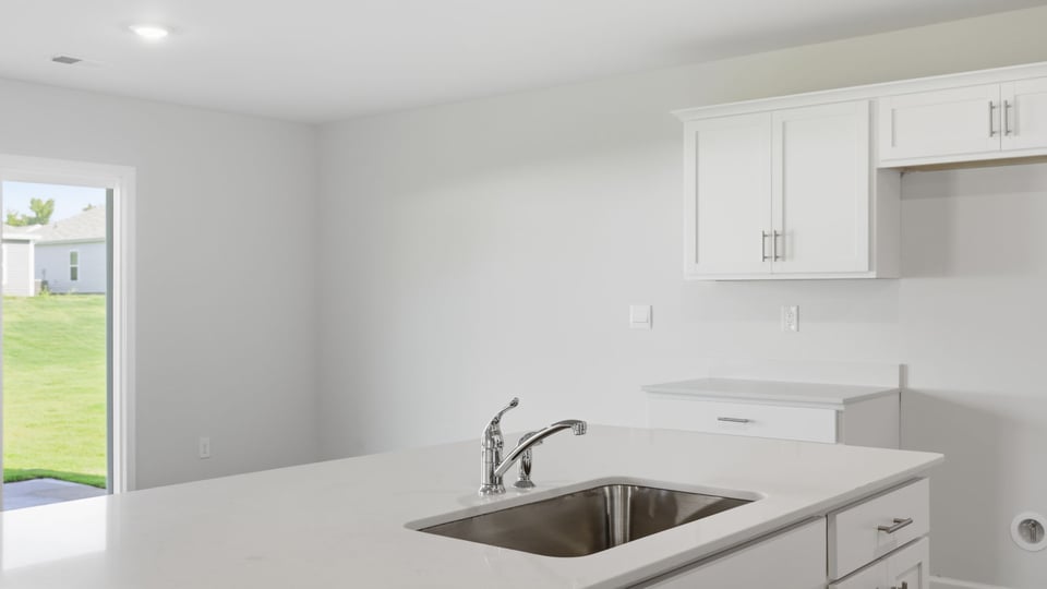 Kitchen and island with quartz countertops.