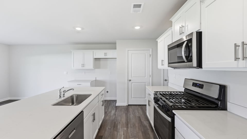Kitchen and island with quartz countertops.