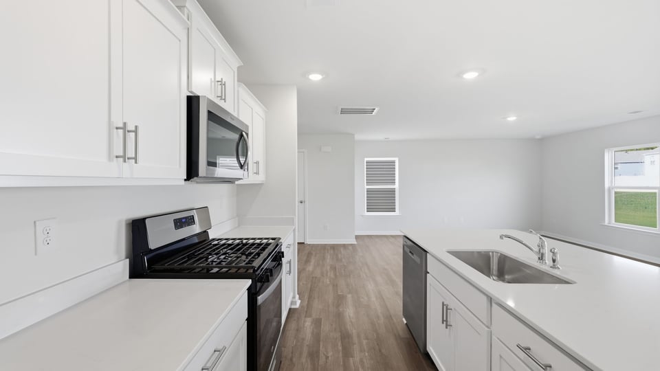Kitchen and island with quartz countertops.