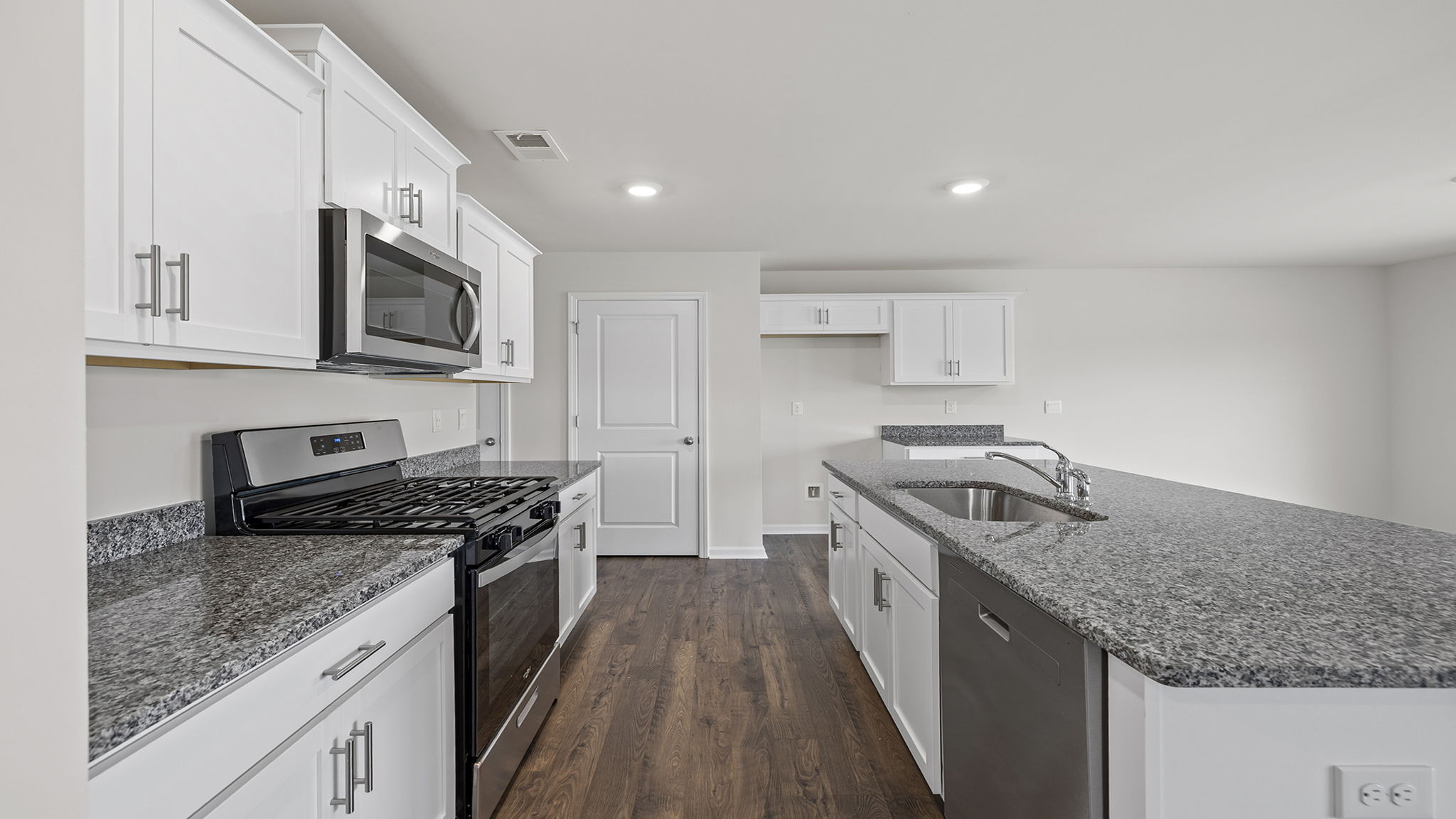 Kitchen with island and cabinets.