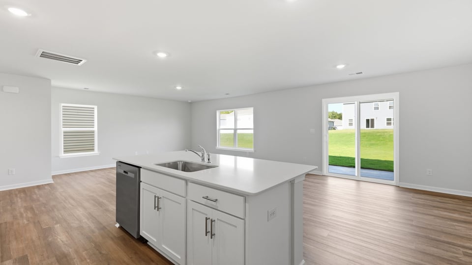 Kitchen and island with quartz countertops.
