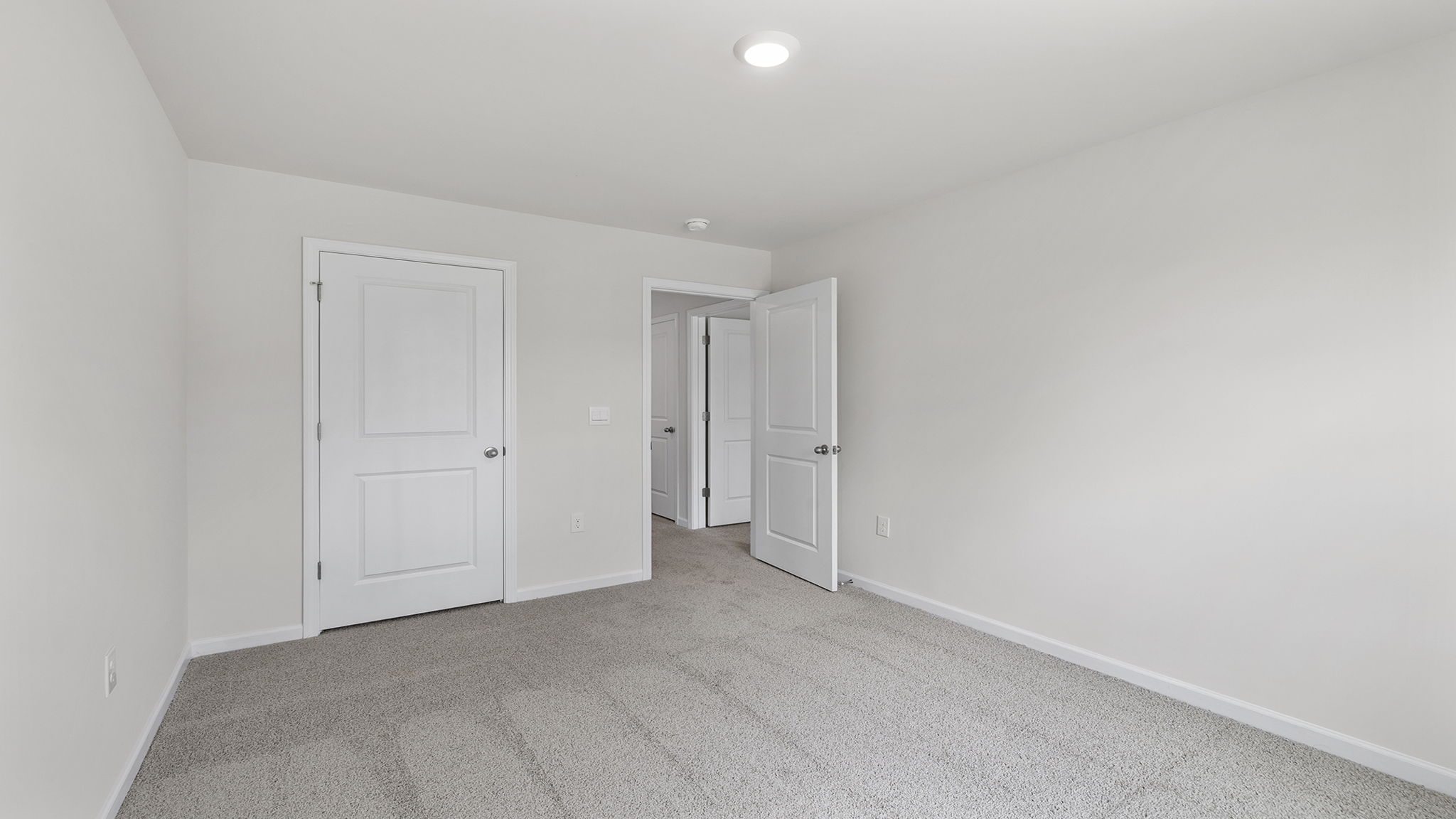 Bedroom with carpet and windows.