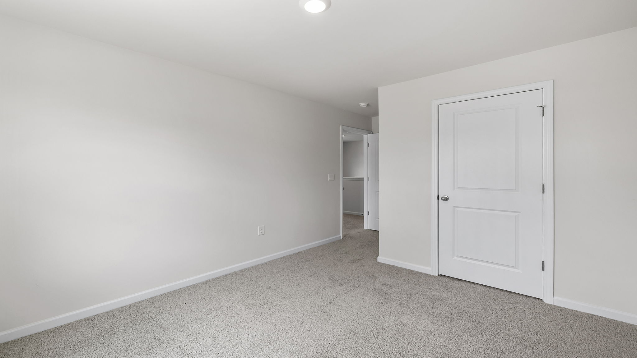 Bedroom with carpet and windows.
