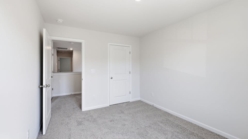 Bedroom with carpet and window.