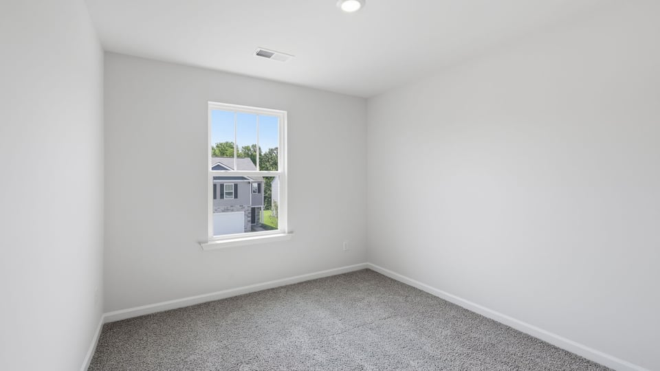 Bedroom with carpet and window.
