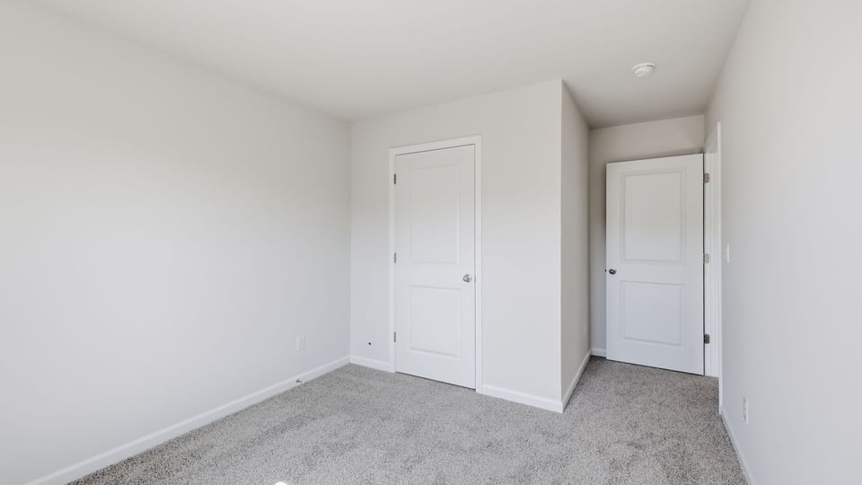 Bedroom with carpet and window.