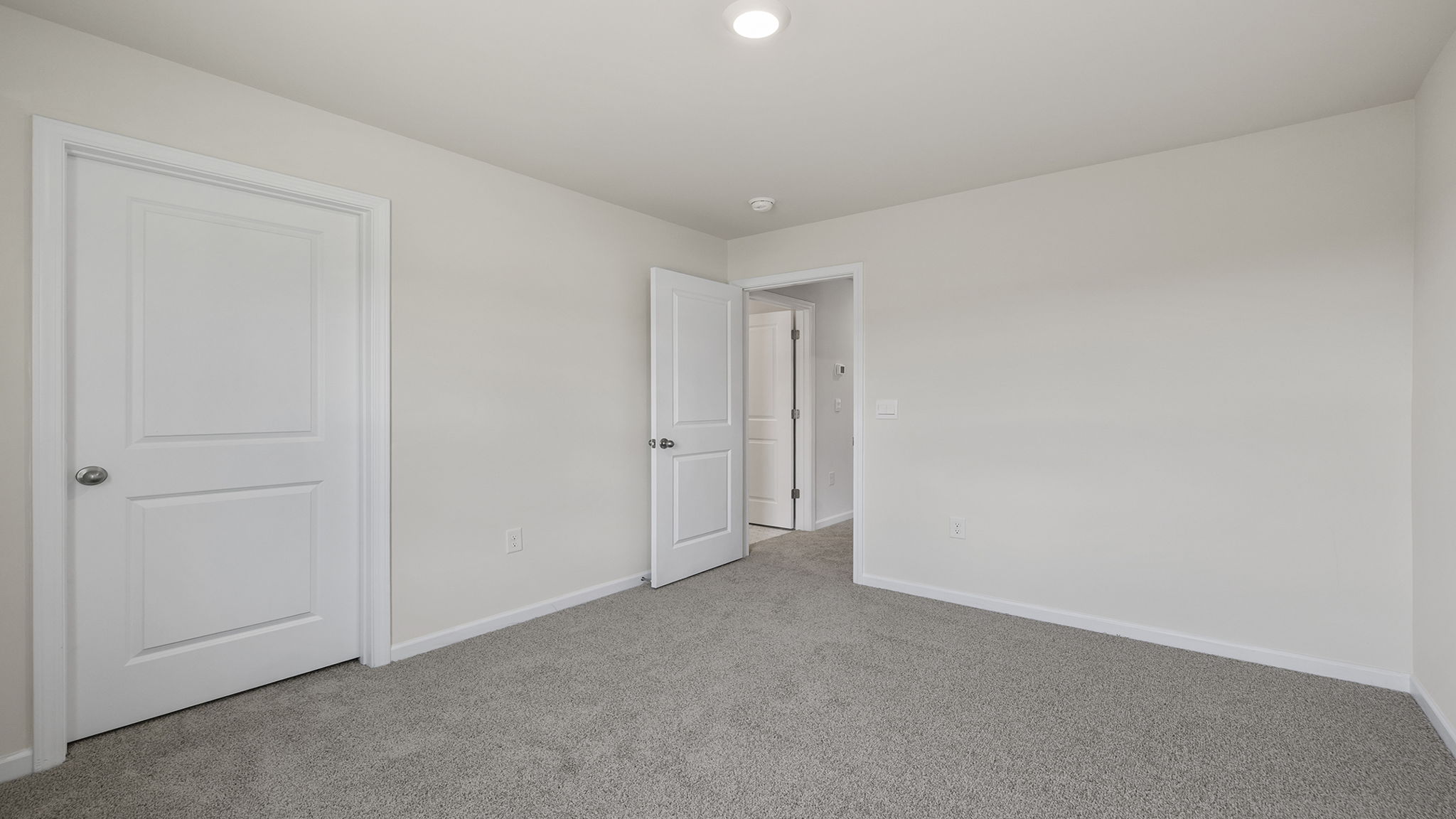 Bedroom with carpet and windows.