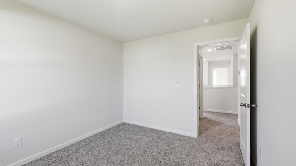 Bedroom with carpet and window.