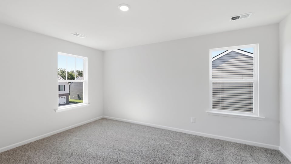 Bedroom with carpet and window.