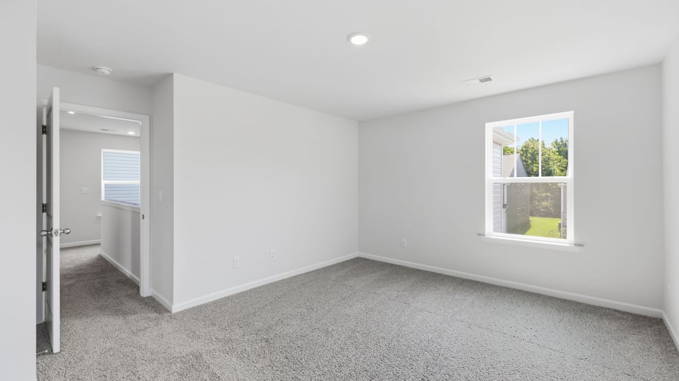 Bedroom with carpet and window.
