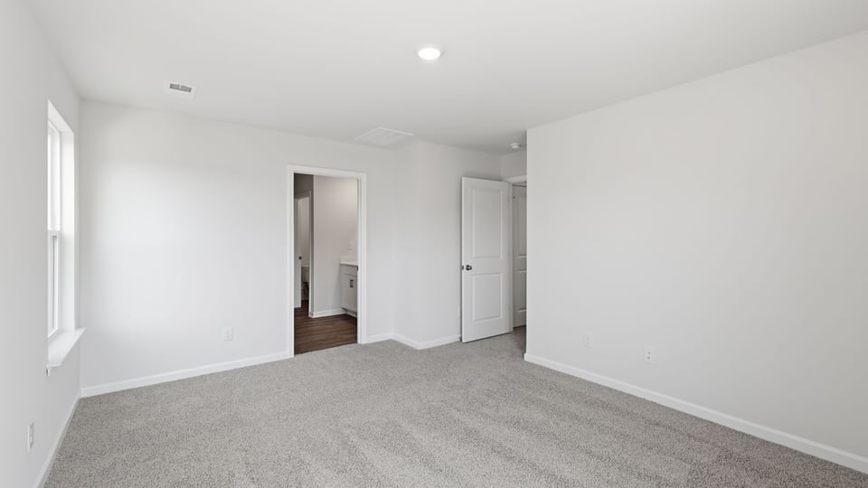 Bedroom with carpet and window.