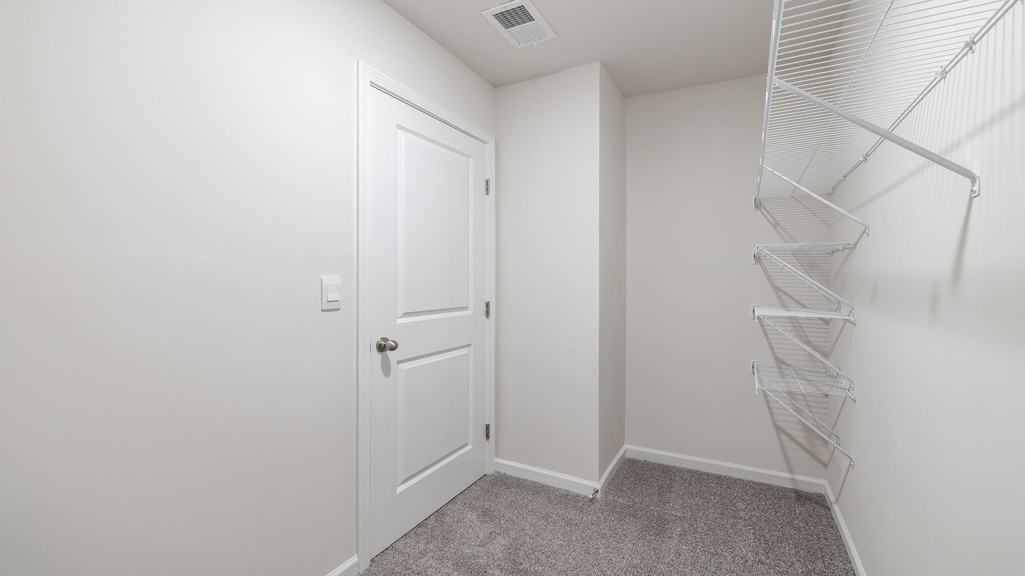 Primary closet with shelf.