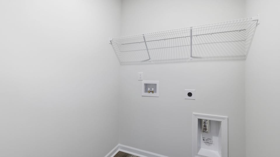 Laundry room with hanging storage racks.