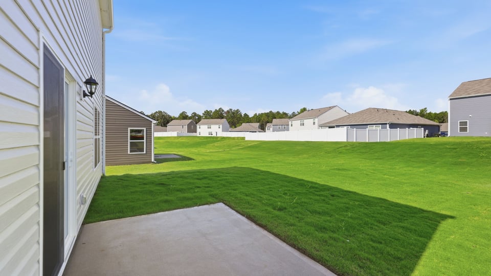 Back exterior of home with patio.