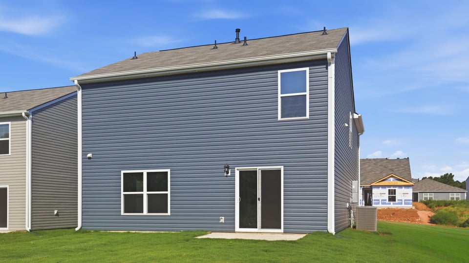 Back exterior with large backyard.