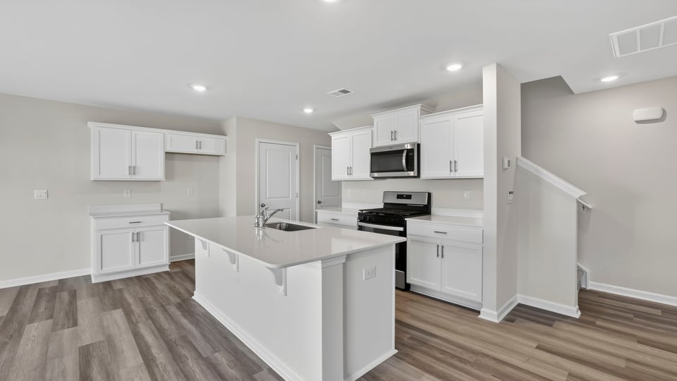 Kitchen with island and cabinets.