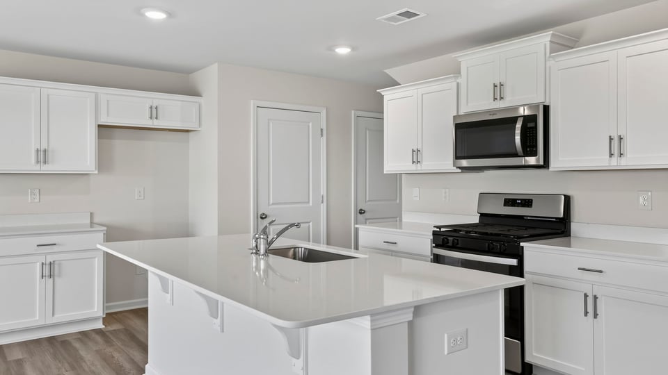 Kitchen with island and cabinets.