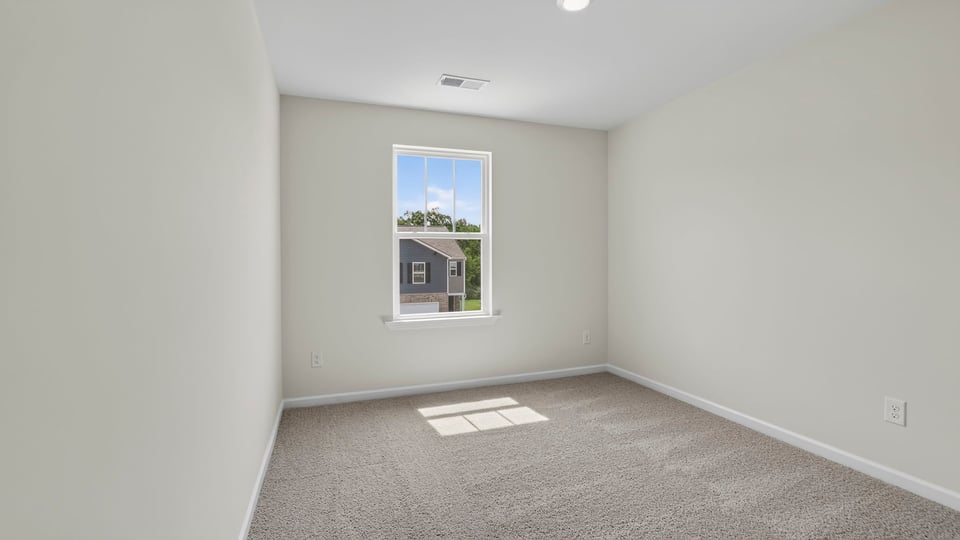Bedroom with carpet and windows.