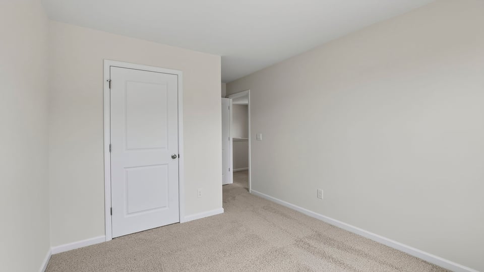 Bedroom with carpet and windows.