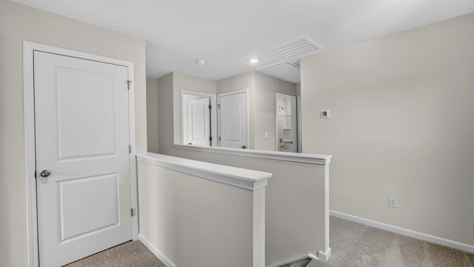 Top of stairs with carpet.