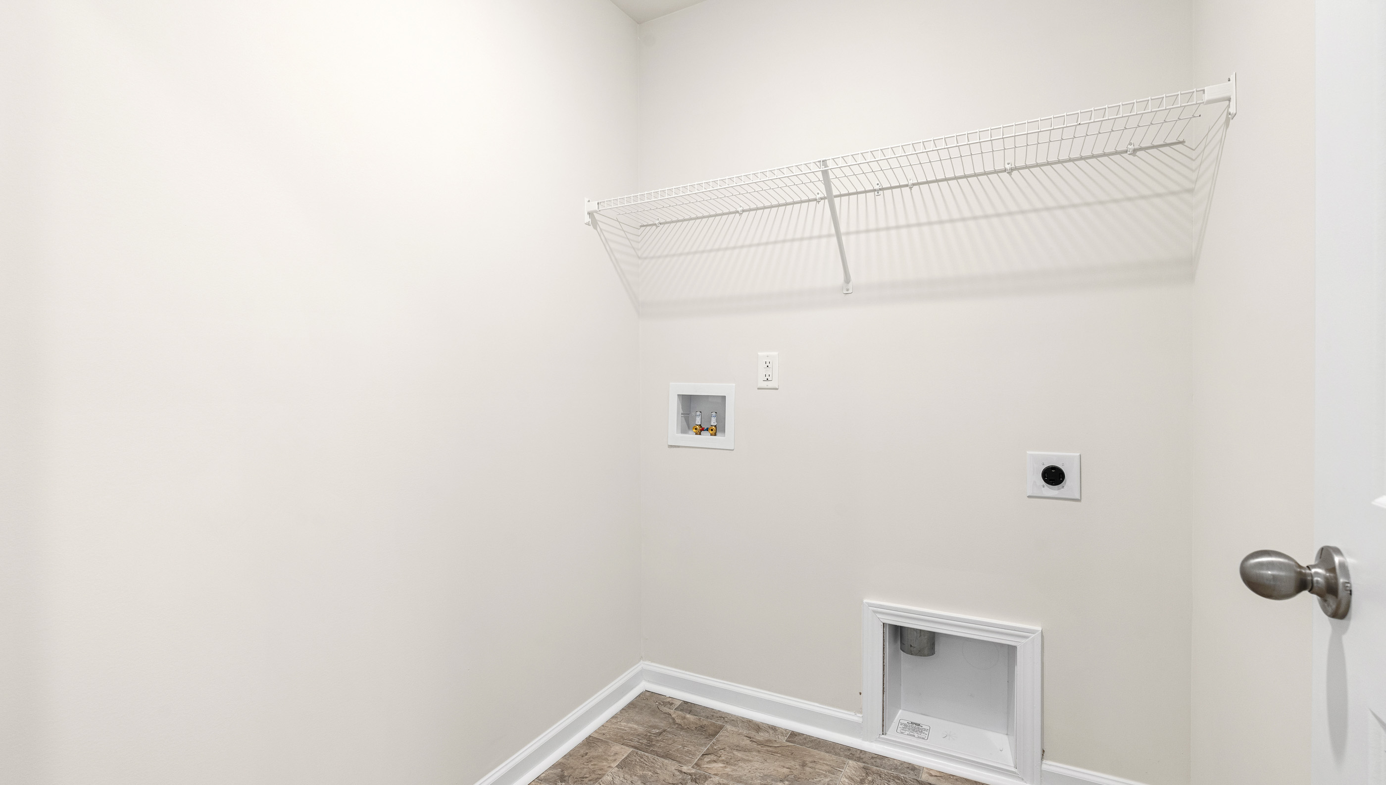 Laundry room with shelf.