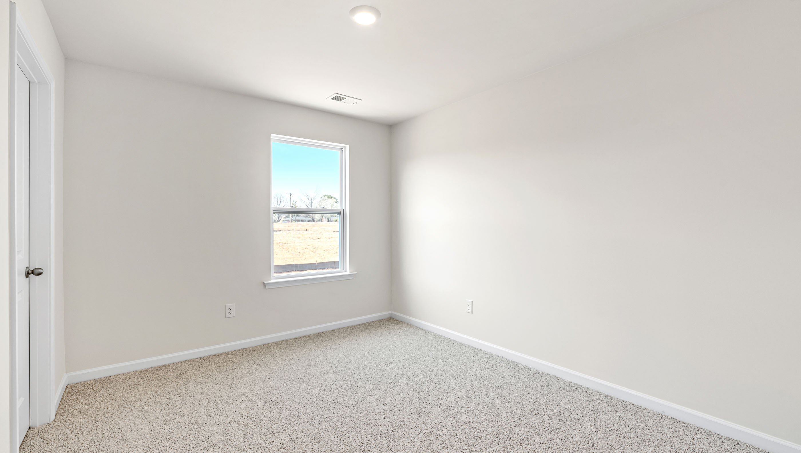 Bedroom with carpet and window.