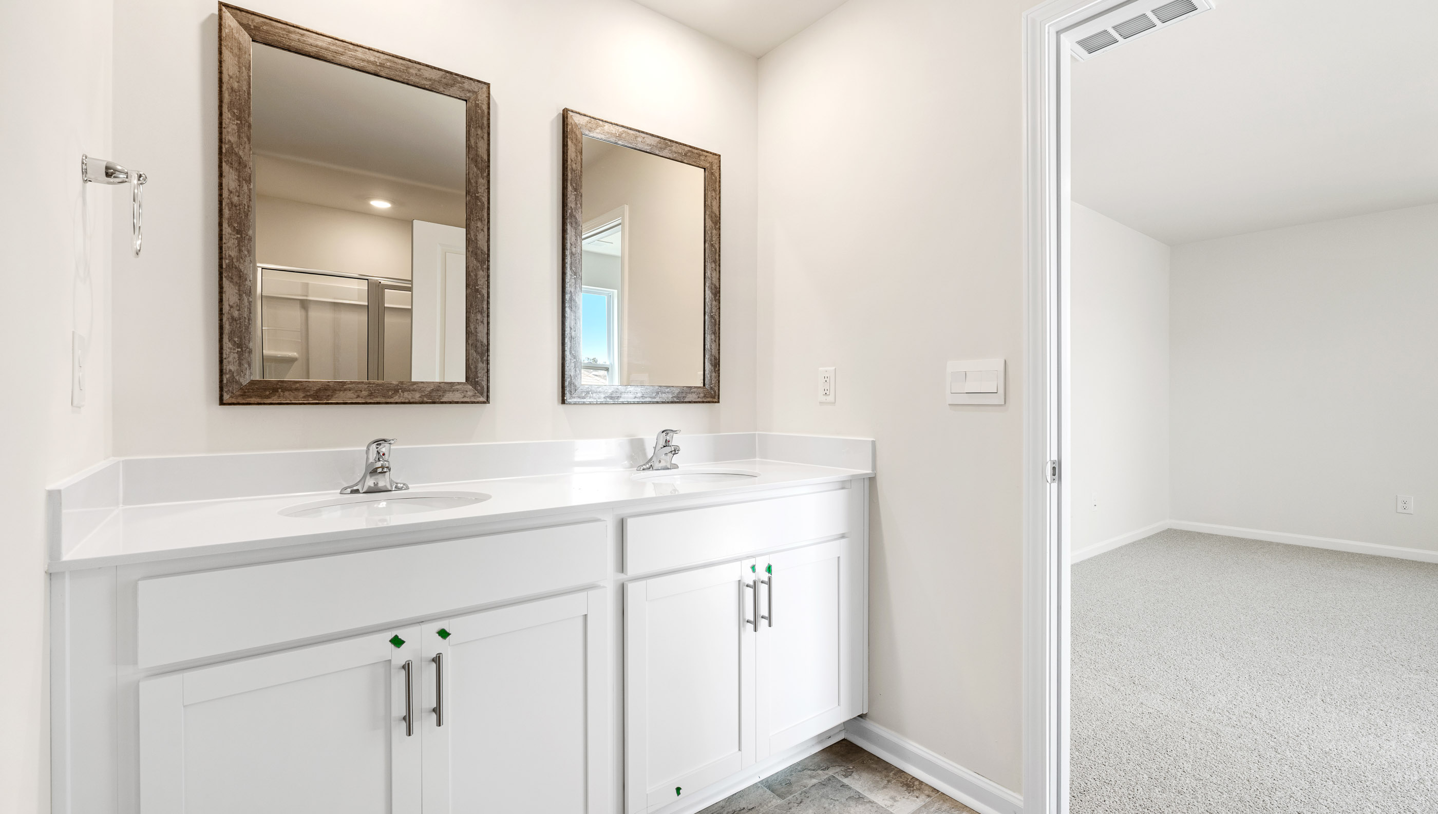 Primary bathroom with double vanities.