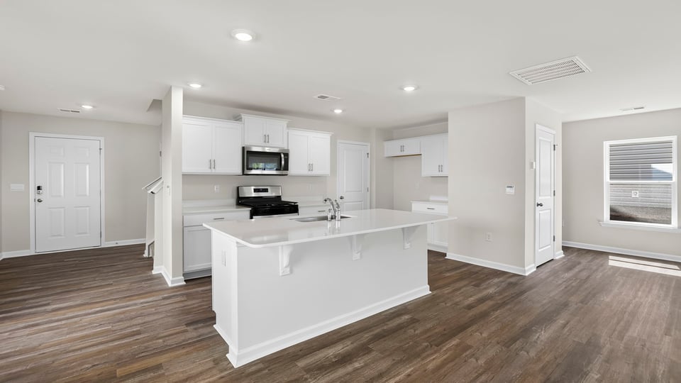 Kitchen with island and cabinets.