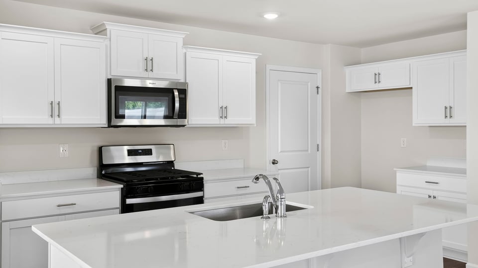 Kitchen with island and cabinets.
